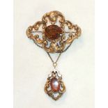 A Victorian brooch of scrolling form set oval citrine, with similarly-set drop below and later