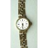 Accurist, a ladies 9ct-gold-cased wrist watch, the circular dial with baton numerals, on gold