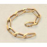 A 9ct gold bracelet of elongated and flattened curb links, with concealed clasp, 19cm long, 26g.