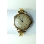 A ladies 9ct-gold-cased wrist watch on plated bracelet.