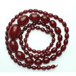 A necklace of cherry-red phenolic Bakelite graduated beads, 92cm long, 68g.