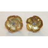 A pair of gold earrings in the form of poppy flowers, each centrally-set an old brilliant-cut