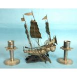 A Chinese white metal model of a three-masted junk, on wooden stand, 13cm wide, 19cm high and a pair