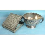 An Oriental white metal square box with hinged cover, embossed with flowers and birds, on ball feet,