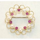 A modern circle brooch, alternately-set seven each round-cut rubies and cultured pearls, within