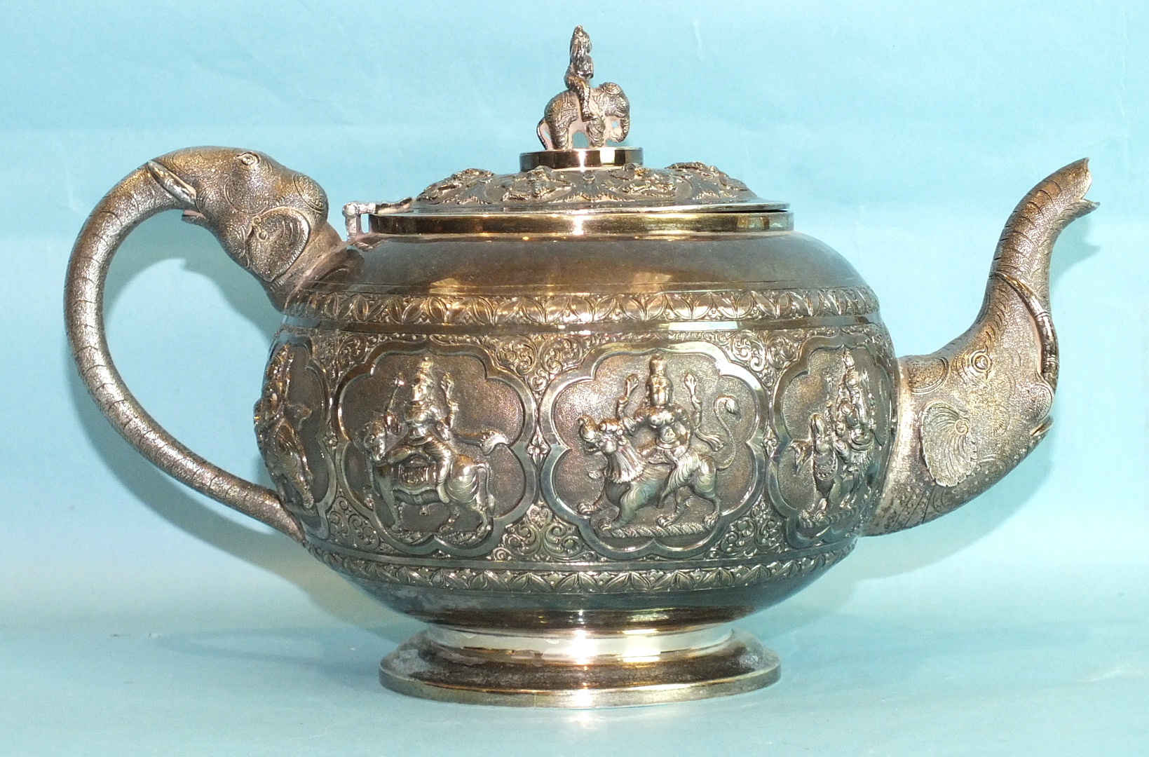 An Indian silver three-piece tea service of circular compressed form, heavily-embossed with panels - Image 2 of 3