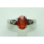 A fire opal-set ring, the oval fire opal claw-set in 18ct white gold mount, with diamond point-set