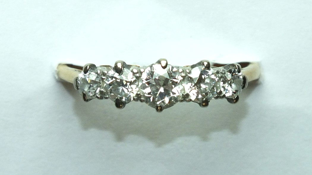 A five-stone diamond ring claw-set five graduated old brilliant-cut diamonds, in 18t gold mount,