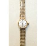 Omega, a ladies 9ct-gold-cased round-faced wrist watch, the silvered dial with baton numerals, on