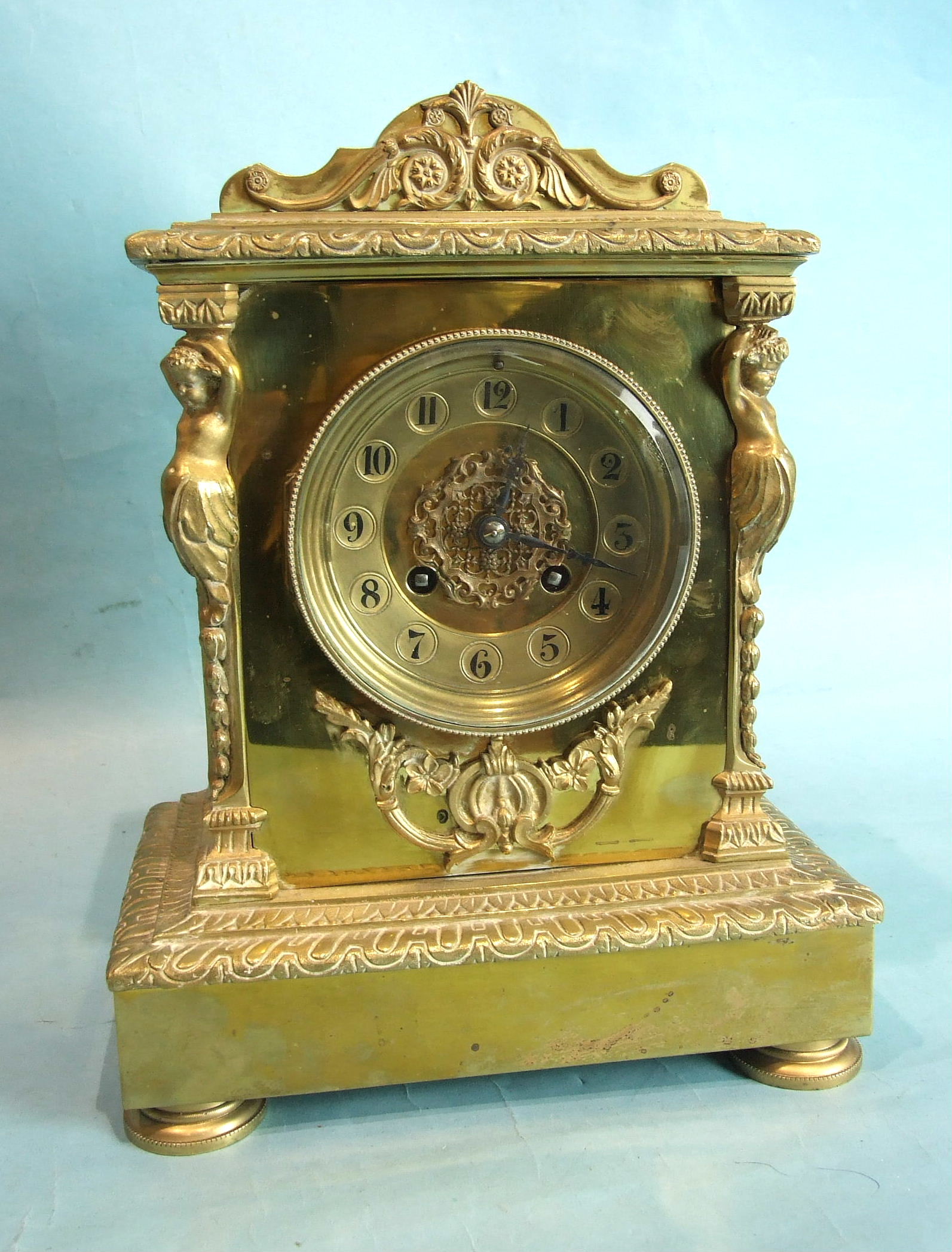 A 19th century French brass mantel clock of caryatid architectural form, with French gong-striking