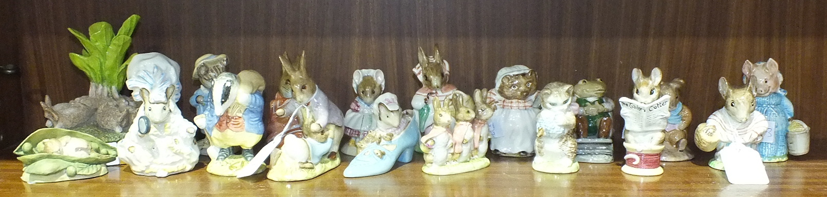 A collection of sixteen Beswick Beatrix Potter figures, including 'Poorly Peter Rabbit', 'Tom Kitten