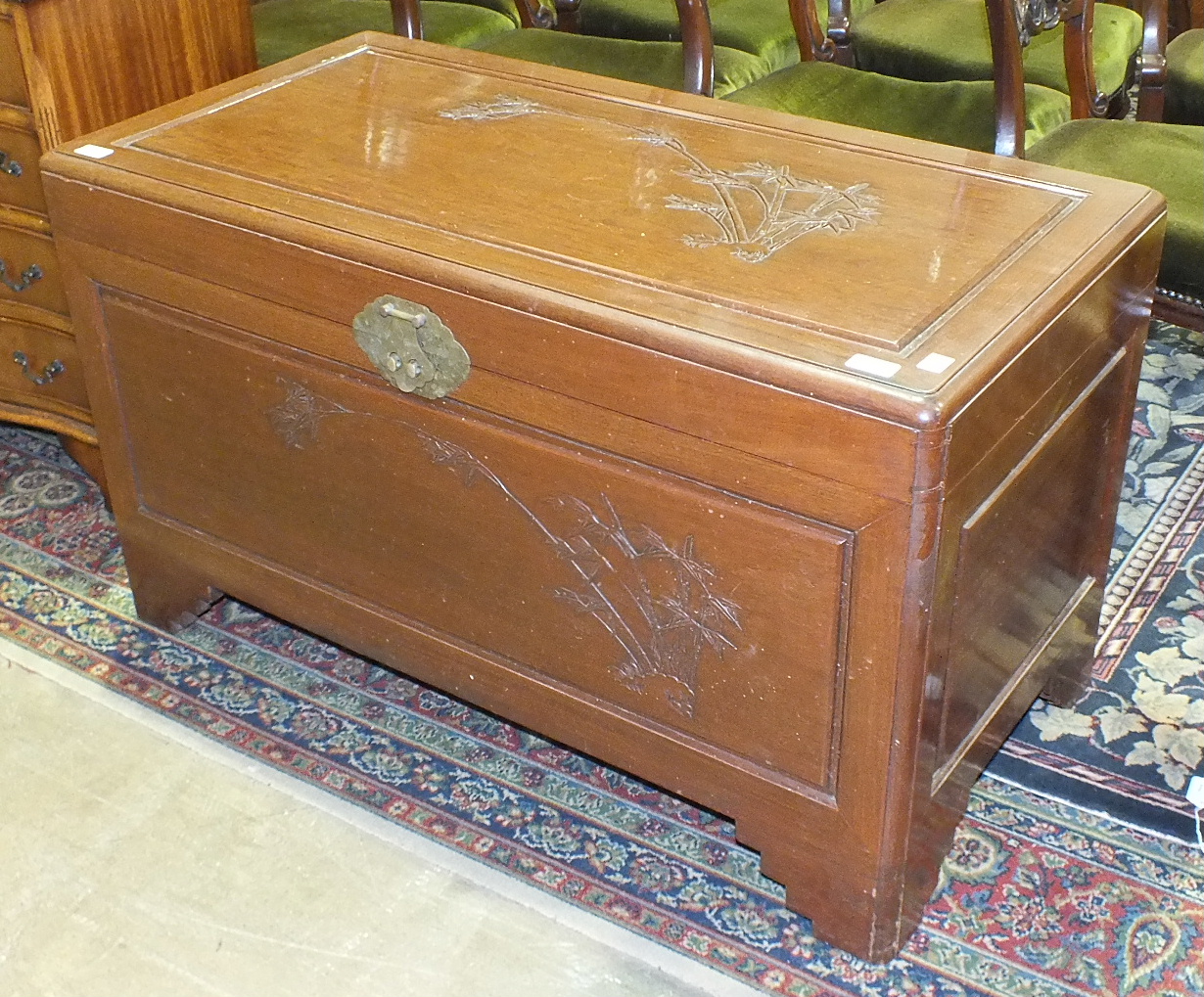 A 20th century camphor-lined blanket chest with carved bamboo decoration on lid and front, 102cm