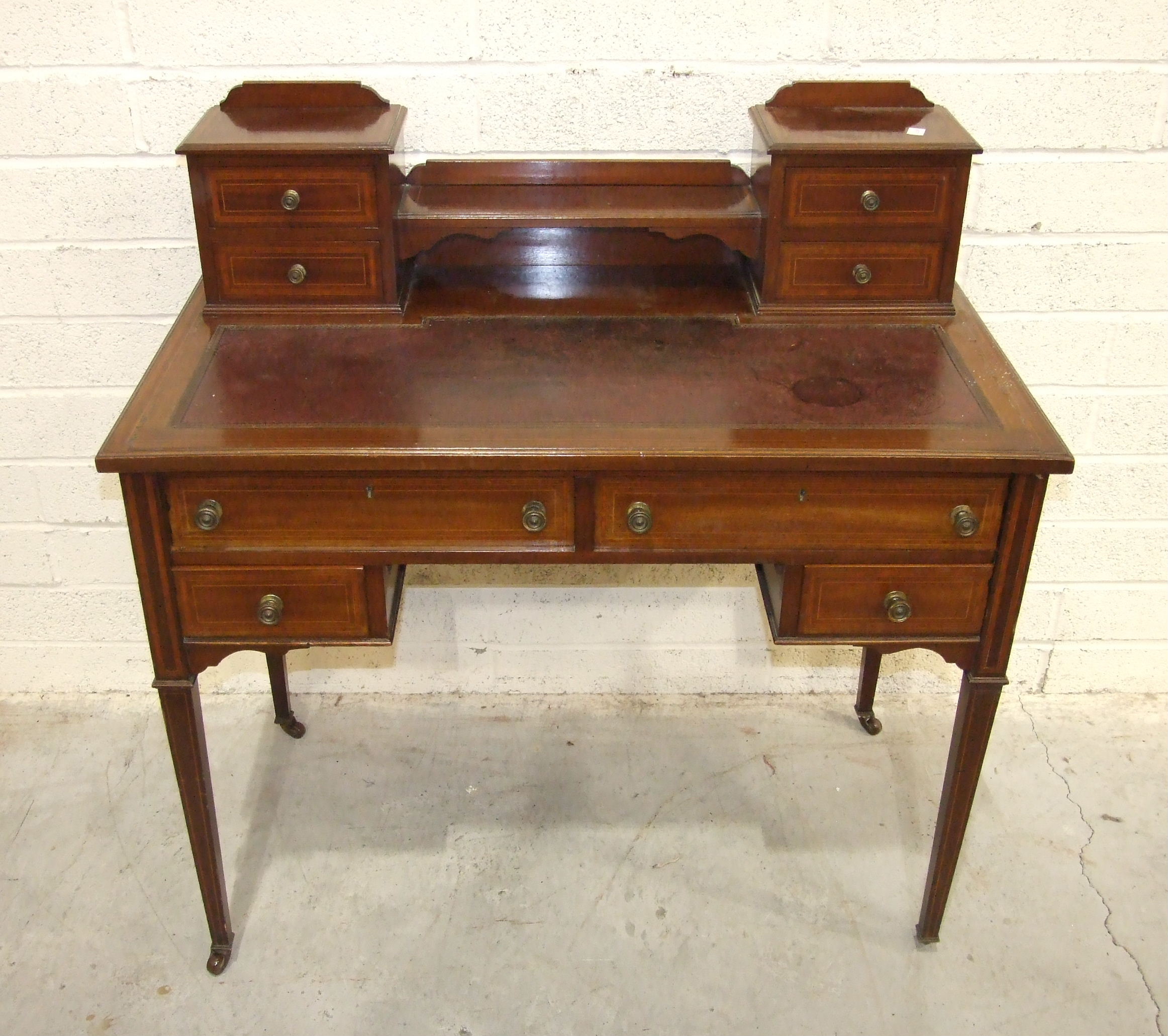 An early-20th century inlaid and cross-banded mahogany lady's writing desk, the top with four