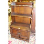 An Ercol bookshelf fitted with a pair of cupboard doors, 61cm wide, 111cm high.