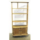 An Ercol light elm 'Giraffe' room divider fitted with three shelves, (two adjustable), above a