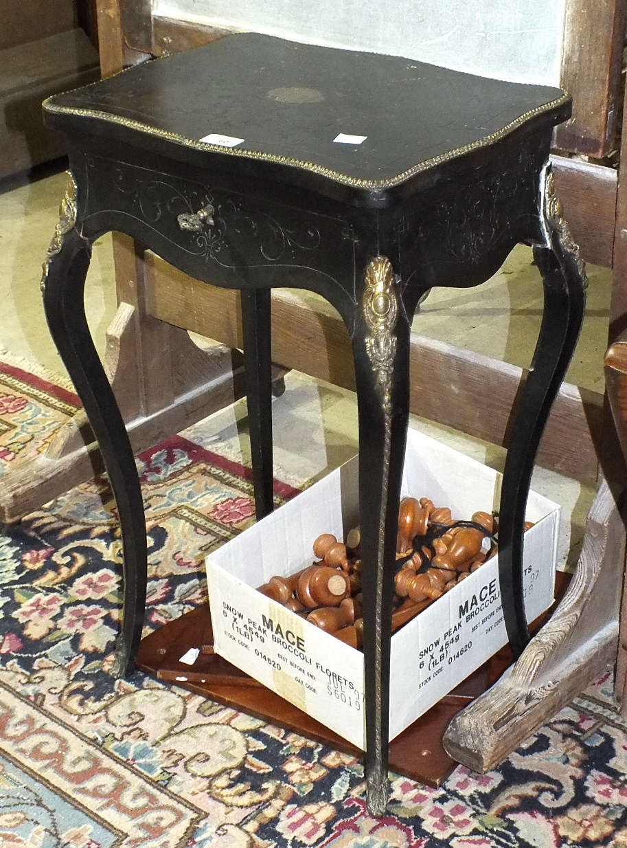 A Continental metal-mounted ebonised work table, (damages to legs), a modern magazine stand, a