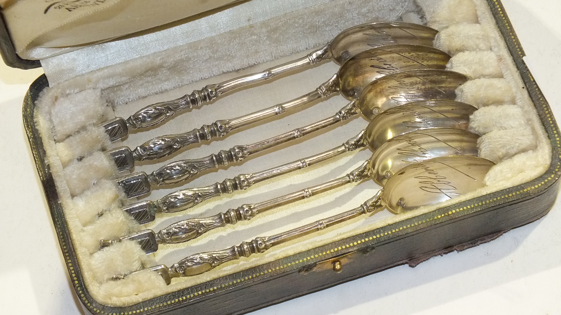 A cased set of six French silver teaspoons, each with crown and coat of arms finial and inscribed "