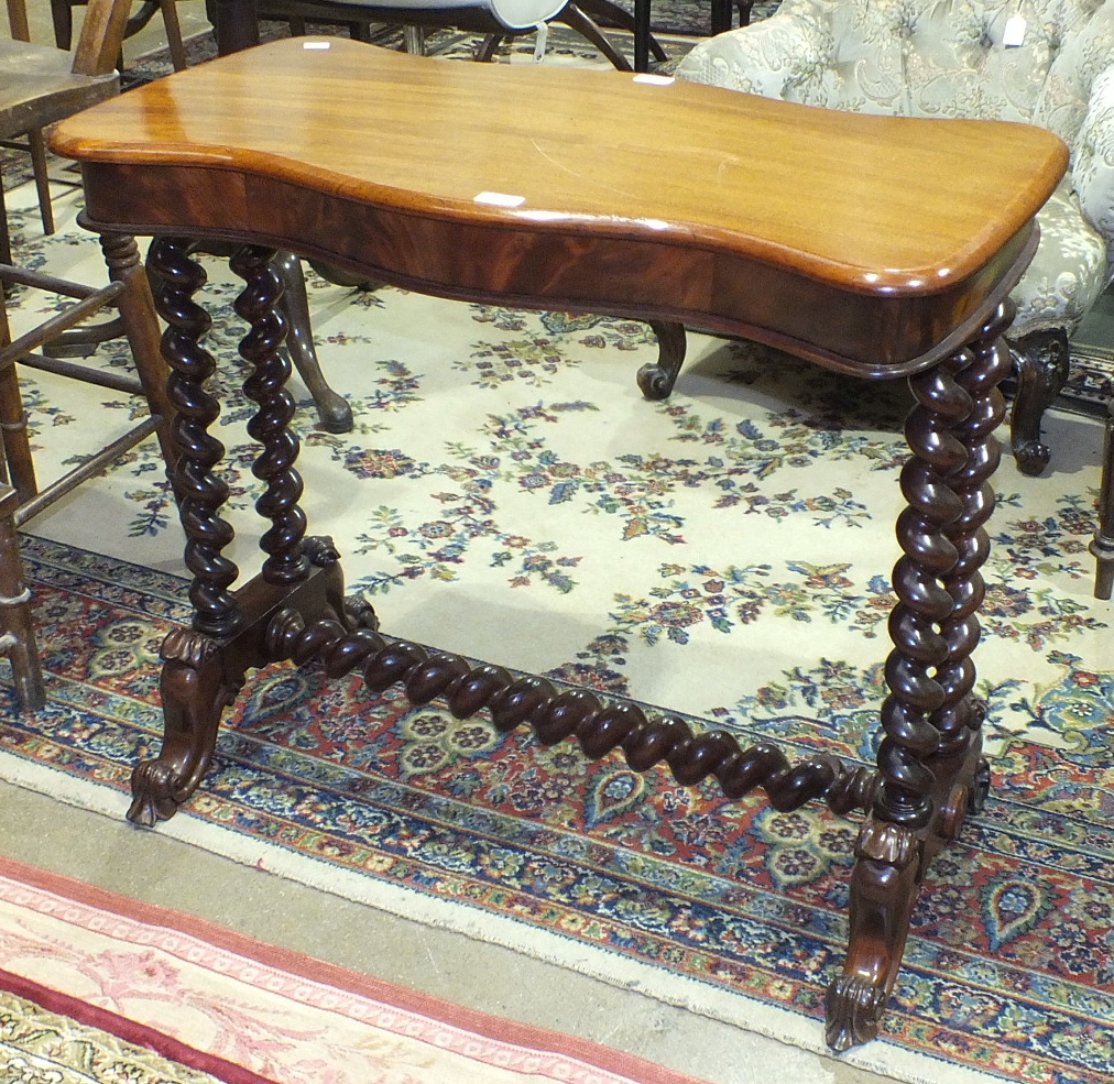 A Victorian mahogany serpentine occasional table on spiral-twist legs and carved end supports, 95