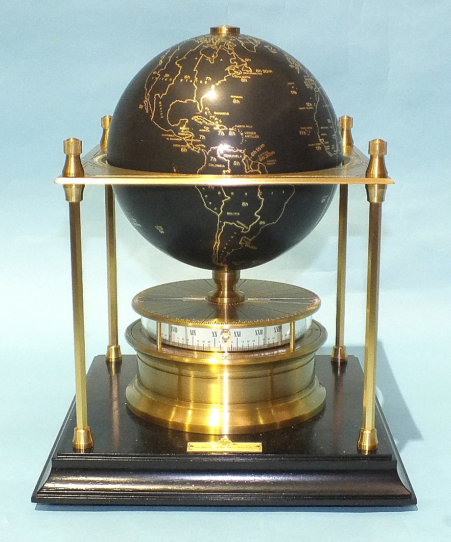 The Royal Geographical Society World Clock, the black gilded globe within a square brass platform,