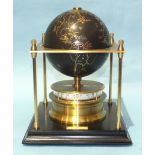 The Royal Geographical Society World Clock, the black gilded globe within a square brass platform,