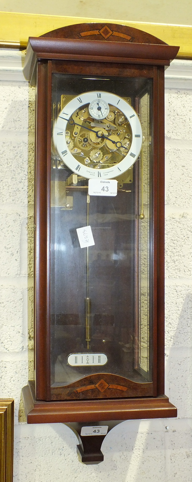 A modern Sewills, Liverpool, mahogany finish chiming wall clock with visible escapement, 58cm