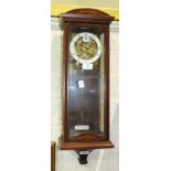 A modern Sewills, Liverpool, mahogany finish chiming wall clock with visible escapement, 58cm