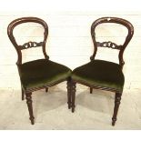 A set of eight Victorian balloon-back mahogany dining chairs with serpentine seats, on fluted turned