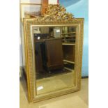 A 19th century gilt gesso rectangular wall mirror with carved crest and leaf-decorated border, 120 x