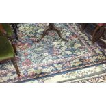 A wool carpet decorated with flowers and foliage on a dark ground, "Le Jardin" by Asiatic Carpets,