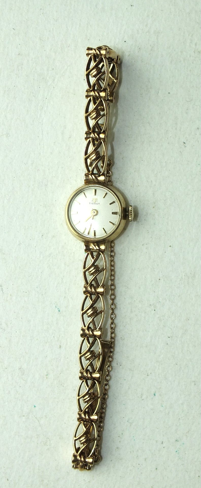 Tissot, a ladies 9ct gold wrist watch, the circular dial with baton numerals, on 9ct gold fancy-link