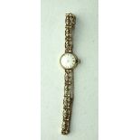 Tissot, a ladies 9ct gold wrist watch, the circular dial with baton numerals, on 9ct gold fancy-link