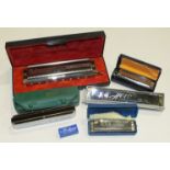 A collection of six harmonicas, including a Hohner Chromonica 280C, a Hohner Echo no.2309, a