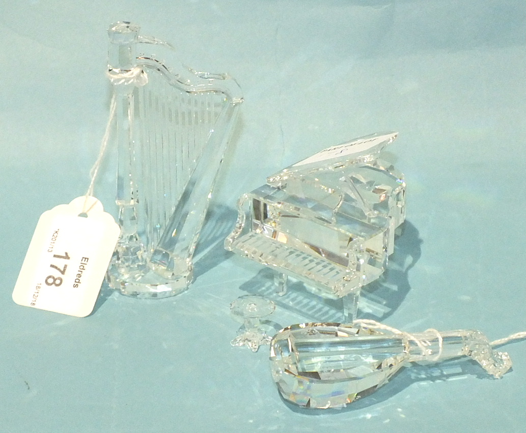 A Swarovski crystal glass model of a grand piano, 7cm high, 6.5cm wide, with stool, a lute and a