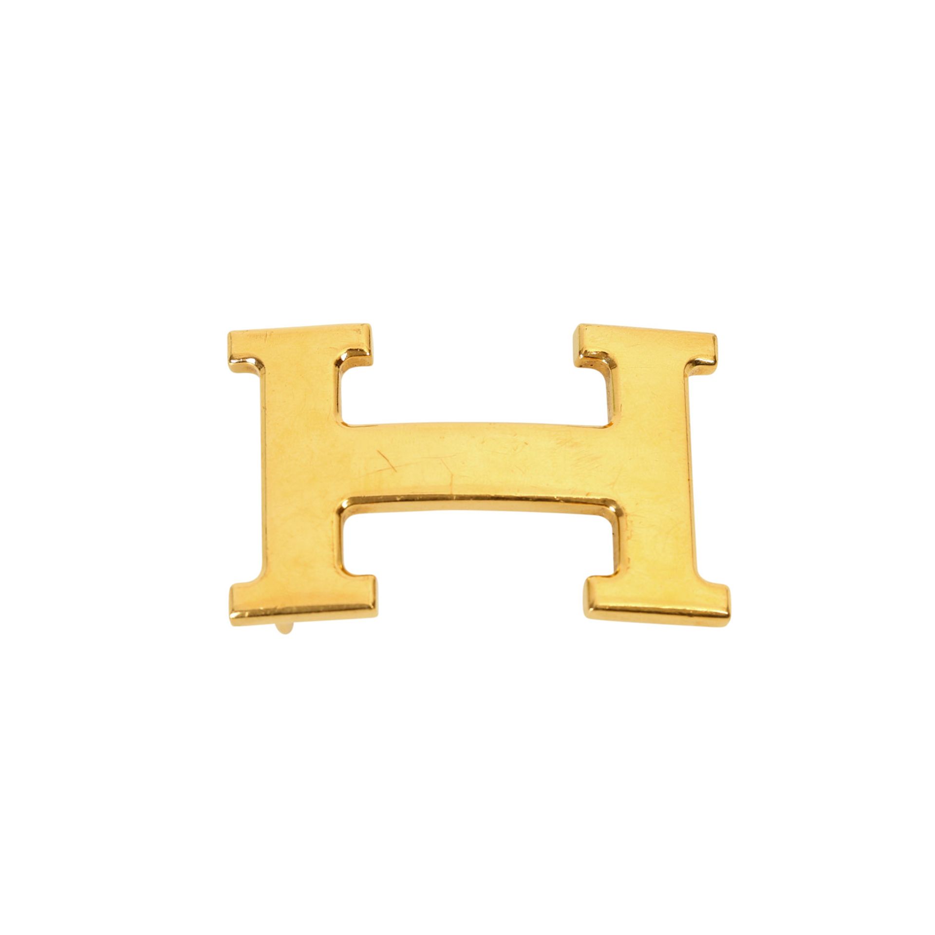 HERMÈS Gürtelschnalle, NP.: ca. 300,-€. Goldfarbene H-Schließe, starke Gebrauchsspuren. L: 6cm B:3,