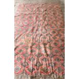Red ground Afghan rug with multiple borders, the centre with repeating medallions, 333cm x 240cm .