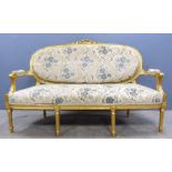 Louis XVI style upholstered gilt framed sofa on turned tapering legs, 156cm wide.