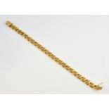 Gold fancy link bracelet, measuring 23cm in length, with hidden clasp, in 18ct yellow gold. Gross
