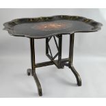 19th century papier mache folding table of serpentine form with tilt top, gilt, mother of pearl