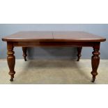 Late 19th/ early 20th century mahogany dining table on turned and reeded supports, with two extra