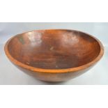 19th century treen bowl with 19th century copper repair to rim diameter 66cm .