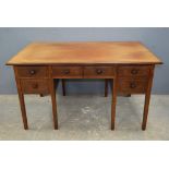 Walnut kneehole desk of five drawers 72 x 131 cms.