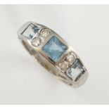 Aquamarine and diamond dress ring, three aquamarines set with four round brilliant cut diamonds,