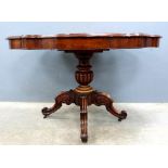 19th century mahogany serpentine centre table with three drawers, column support, and splayed