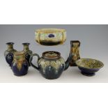 A group of Doulton stoneware, a pair of vases with formal decoration of flowers, similar tea pot and