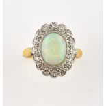 Opal and diamond cluster ring, oval cabochon cut opal, estimated weight 1.27 carats, set within a