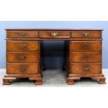 20th century walnut pedestal desk of nine drawers on ogee bracket feet, 75cm x 140cm . kneehole