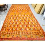 Orange ground rug with multiple borders, the centre with multiple shaped medallions, 280cm x 136cm .