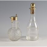 Silver collared glass decanter and a claret jug with silver mounts,.