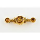 Victorian citrine brooch, central round cut citrine, flanked by two others, estimated total weight