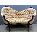 A mahogany framed upholstered button back sofa.. Carved top rails both have been repaired, back